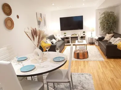 a living room with a table and a couch at Cozy suite, Free WIFI , Free Parking in Calgary