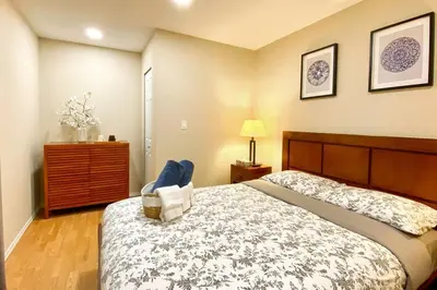 a bedroom with a bed and a chair in it at Beaver Beach Vacation Home in Madeira Park