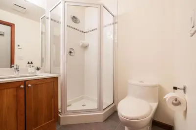 a bathroom with a shower and a toilet and a sink at Deer Run by Outpost Whistler in Whistler