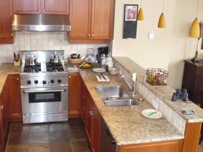 a kitchen with a stove and a sink at Whistler Ski In Ski Out in Whistler