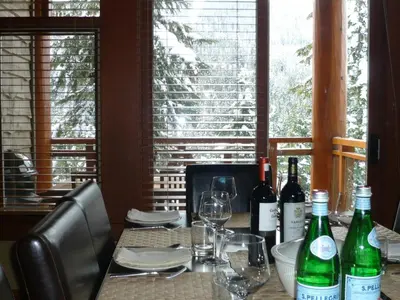 a table with wine bottles and glasses on it at Whistler Ski In Ski Out in Whistler