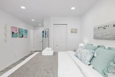 a white living room with a white couch at Serenity 1BR & 1 DEN Home at Folsom Ave in Coquitlam