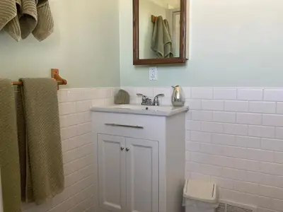a white bathroom with a sink and a mirror at Tudor House Bed and Breakfast in Bottrel