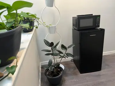 a microwave oven sitting on top of a black cpu at Vancouver Airport 7 mins away Cozy room Richmond near YVR in Richmond