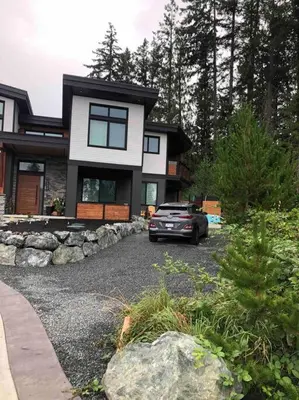 a car parked in front of a house at Executive 1 Bedroom Lakeview Retreat in Shawnigan Lake