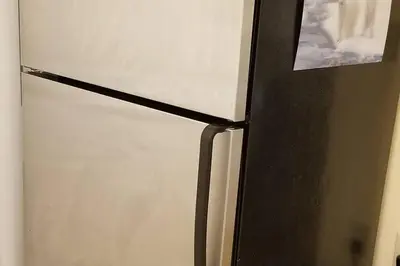 a black and white refrigerator with a picture on it at Bright 2 BR, Great Location in West Vancouver