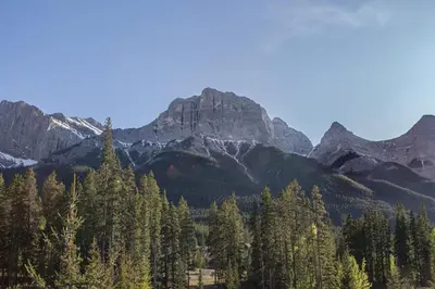 a group of trees with mountains in the background at Worldmark Canmore Banff Alberta Canada in Canmore
