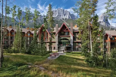 a large building with a mountain in the background at Worldmark Canmore Banff Alberta Canada in Canmore