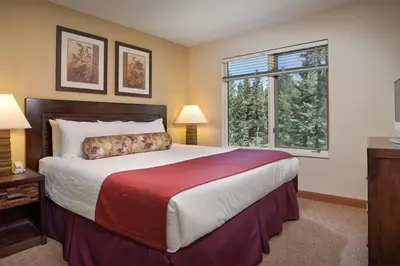 a bedroom with a large bed and a window at 2 Bd Worldmark Canmore Banff Condo in Canmore