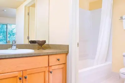 a bathroom with a sink and a toilet and a shower at 2 Bd Worldmark Canmore Banff Condo in Canmore