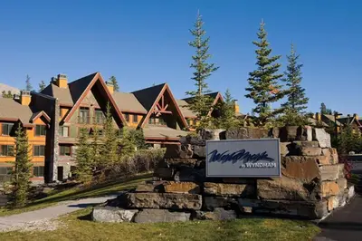 a sign on a stone wall in front of a house at 2 Bd Worldmark Canmore Banff Condo in Canmore