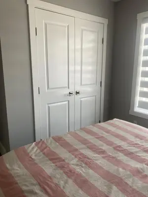 a bedroom with a bed with a striped blanket at Empress moment place #602 in Calgary