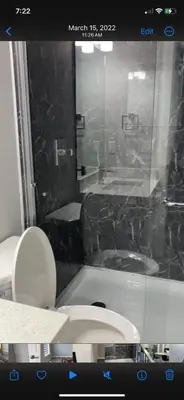 a bathroom with a tub and a toilet and a sink at Empress moment place #602 in Calgary