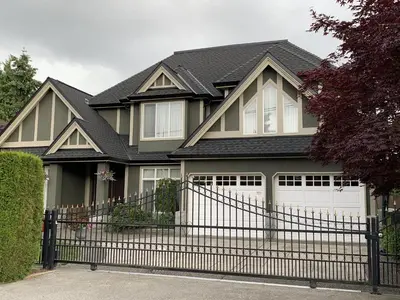 a house with a black fence and a white garage at Richmond Garden Retreat in Richmond