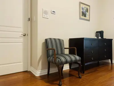 a chair sitting next to a dresser in a room at Richmond Garden Retreat in Richmond