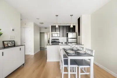 a kitchen and dining room with a table and chairs at Lovely condo with amazing view in Vancouver