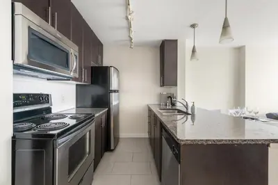 a kitchen with a stove and a microwave at Lovely condo with amazing view in Vancouver