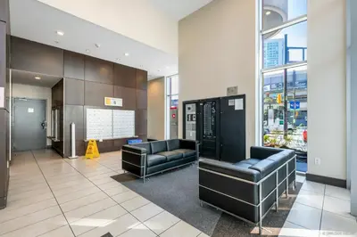 a waiting room with two leather chairs in a building at Lovely condo with amazing view in Vancouver