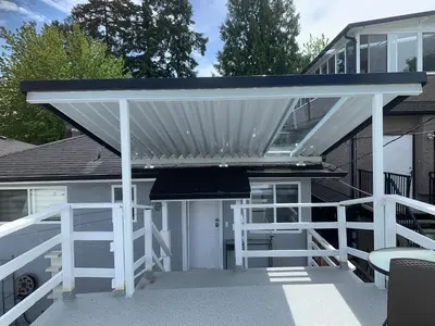 a white pergola on a porch of a house at Exclusive Offer - A special deal ending soon!! Super Nice Location - Very close to YVR Airport and shopping center & easy transportation in Vancouver