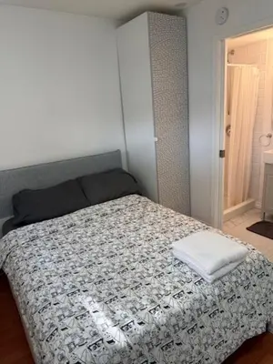 a bedroom with a bed with a pillow on it at Exclusive Offer - A special deal ending soon!! Super Nice Location - Very close to YVR Airport and shopping center & easy transportation in Vancouver