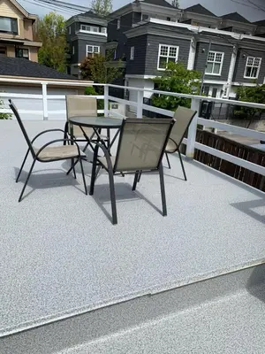 a patio with a table and chairs on a roof at Exclusive Offer - A special deal ending soon!! Super Nice Location - Very close to YVR Airport and shopping center & easy transportation in Vancouver