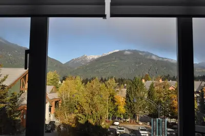 a view of a mountain from a window at Upscale Modern Apartment in Whistler