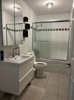 a bathroom with a sink and a toilet and a shower at Vancouver airport 7mins away joy room in Richmond