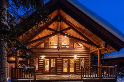 a log cabin with a large window at GrizzPaw Lodge - Mountain Resort - 5 Bedroom Chalet - Sleeps 14 People in Golden