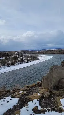 a body of water with snow on the shore at Entire guest suite in Cochrane, AB in Cochrane