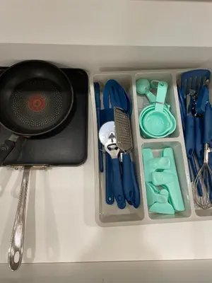 a container filled with utensils and a utensil at Spacious Forested Garden Suite in North Vancouver