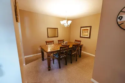 a dining room with a wooden table and chairs at Peaks of Radium by StayIn in Radium Hot Springs