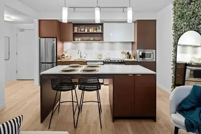 a kitchen with a large island with two bar stools at Your Own Private Oasis In Victoria in Victoria
