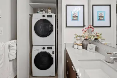 a washer and dryer in a bathroom with a sink at Your Own Private Oasis In Victoria in Victoria