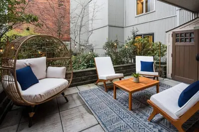 a patio with wicker chairs and a table and a wicker swing at Your Own Private Oasis In Victoria in Victoria