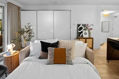 a living room with a couch with pillows on it at Your Own Private Oasis In Victoria in Victoria