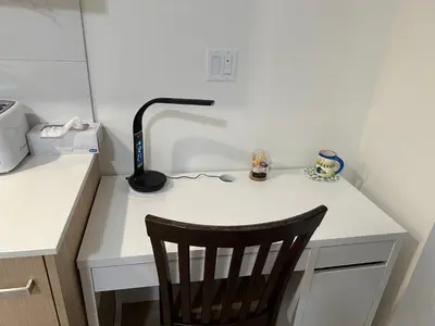 a desk with a lamp and a chair on it at New condo near Lougheed Mall & SFU in Coquitlam