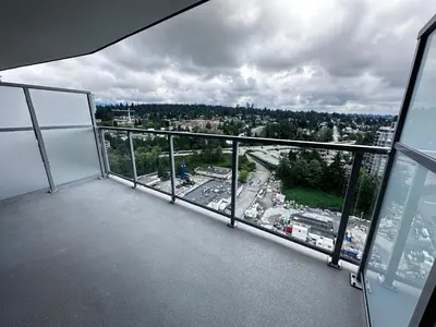 an empty balcony with a view of a city at New condo near Lougheed Mall & SFU in Coquitlam