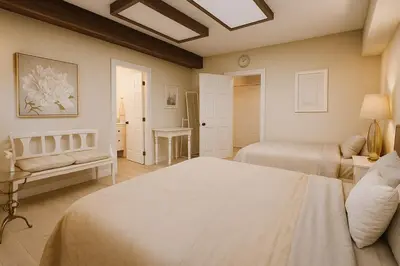 a bedroom with two beds and a couch at Bright Spacious 3 BR Garden Suite, 4 Queen beds, Fully equipped, Highly recommended by 229 happy groups in Burnaby
