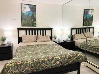 a bedroom with two beds and two lamps at Bright Spacious 3 BR Garden Suite, 4 Queen beds, Fully equipped, Highly recommended by 229 happy groups in Burnaby