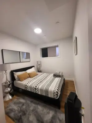 a bedroom with a bed in a room at Pebbles' Cozy 2Bed Basement Suite - near Downtown in Edmonton