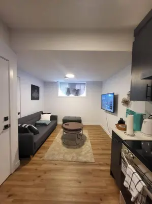 a living room with a couch and a table at Pebbles' Cozy 2Bed Basement Suite - near Downtown in Edmonton