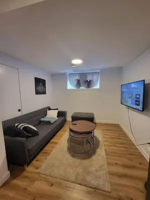 a living room with a couch and a table at Pebbles' Cozy 2Bed Basement Suite - near Downtown in Edmonton