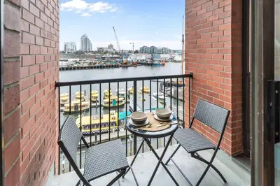 a balcony with a table and chairs and a harbor at Water Views From Every Window in Victoria