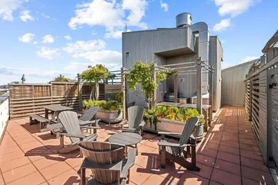 a patio with chairs and tables on a roof at Water Views From Every Window in Victoria