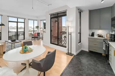 a kitchen and living room with a table and chairs at Water Views From Every Window in Victoria