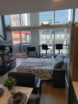 a room with a bed and a table and chairs at New York Style Loft in Downtown Vancouver-Ideal for World Cup 2026, Sleeps 4 in Vancouver