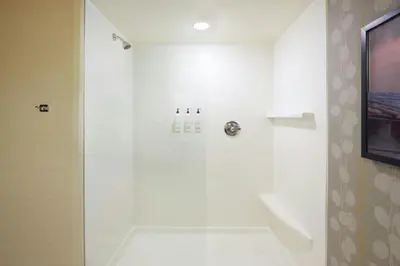 a bathroom with a shower with a glass door at Fairfield Inn & Suites by Marriott Calgary Downtown in Calgary