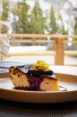 a piece of cake on a plate on a table at The Lodge at Bow Lake in Lake Louise