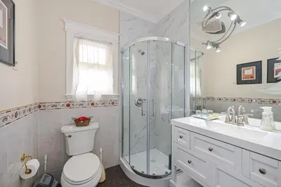 a bathroom with a shower and a toilet and a sink at 7 Bedrooms in the Heart of Vancouver in Vancouver