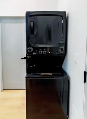 a microwave oven sitting on top of a table at LuxQuarters Bumbleberry Guest House in Kitimat